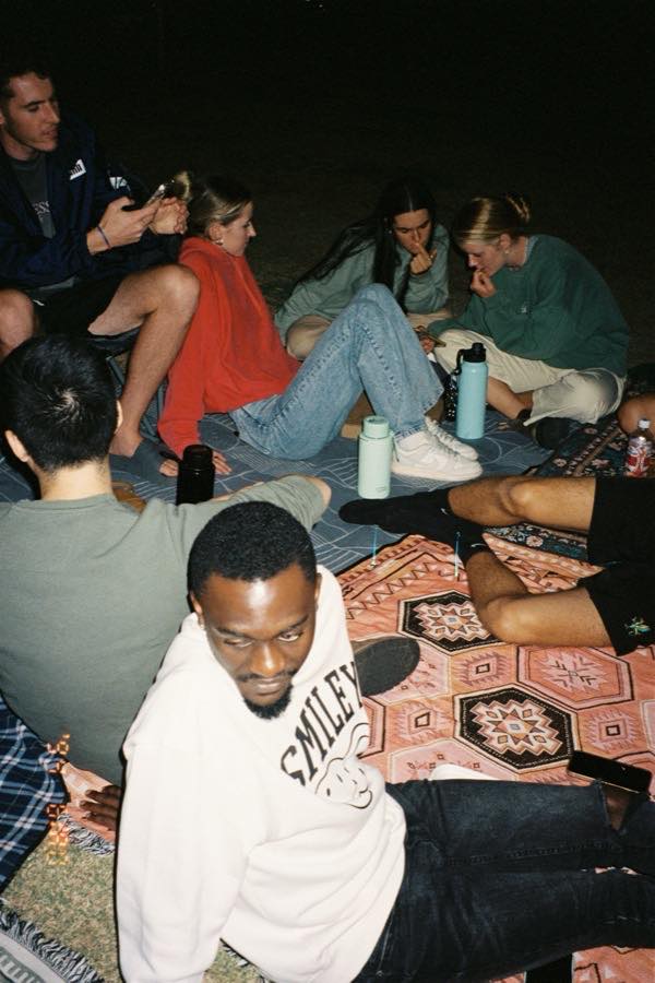 A crowd at a branded event adding photos to one shared album from their own phones