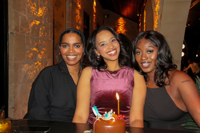 Three friends with a birthday cake