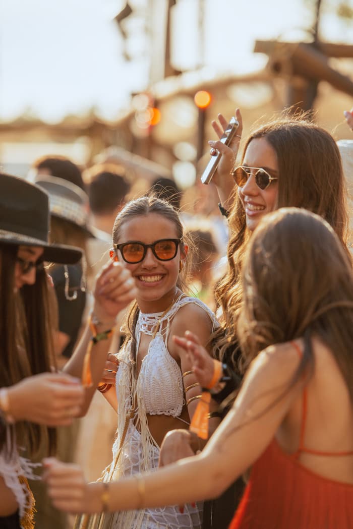 Friends laughing in the sun at a festival