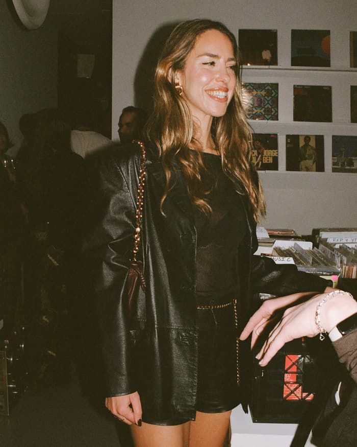 A guest smiling at a gallery opening