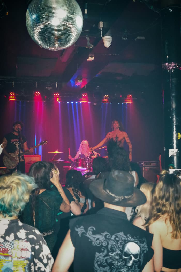 A crowd watching a band in a small venue