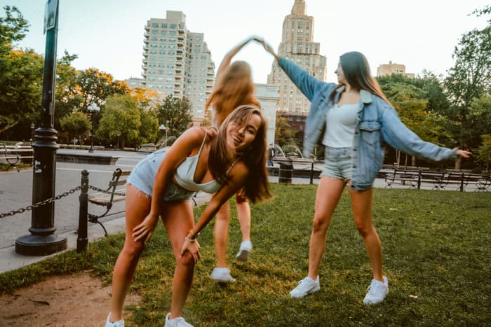 Friends dancing in a city park